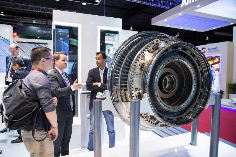 Trade visitors and exhibitor networking at a Singapore Airshow exhibit